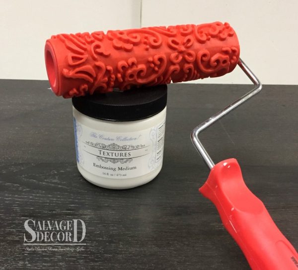 Repairing a damaged top with a textured finish using a decorative art roller and embossing medium.